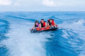 elite pearl charter - three people enjoying the rush of riding the donut.