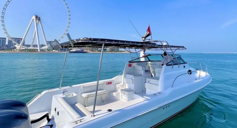 Elite Pearl Charter 31 ft Gulf Craft fishing boat with its crew aboard off Bluewaters Island, the Ain Dubai wheel behind