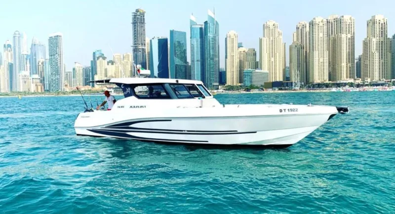 Elite Pearl Charter 36 ft fishing boat cruising the turquoise water off the Dubai Marina skyline